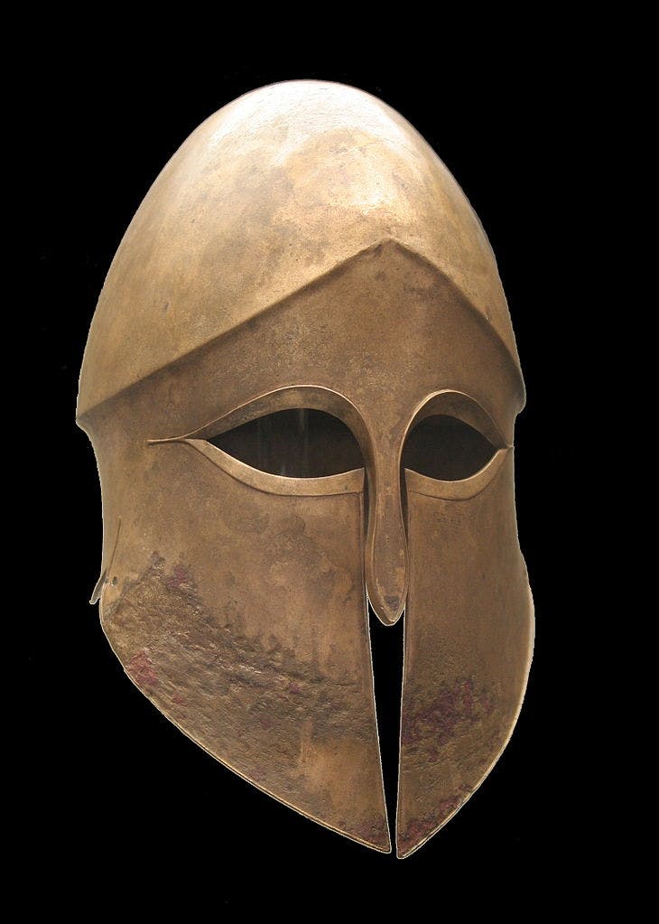 Corinthian greek helmet (by Staatliche Antikensammlungen, CC BY-SA 3.0 Wikimedia Commons)